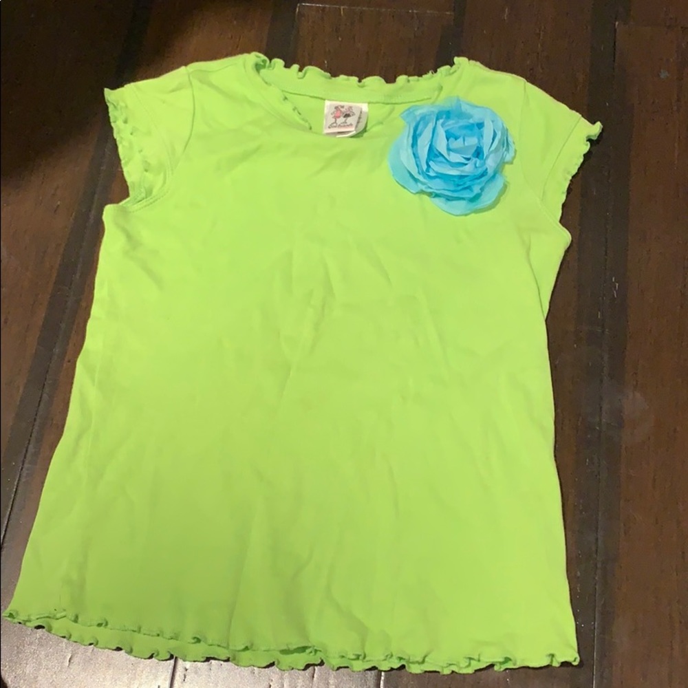 green top with blue flower